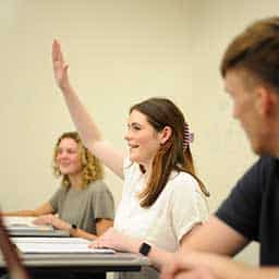 student raising hand in class