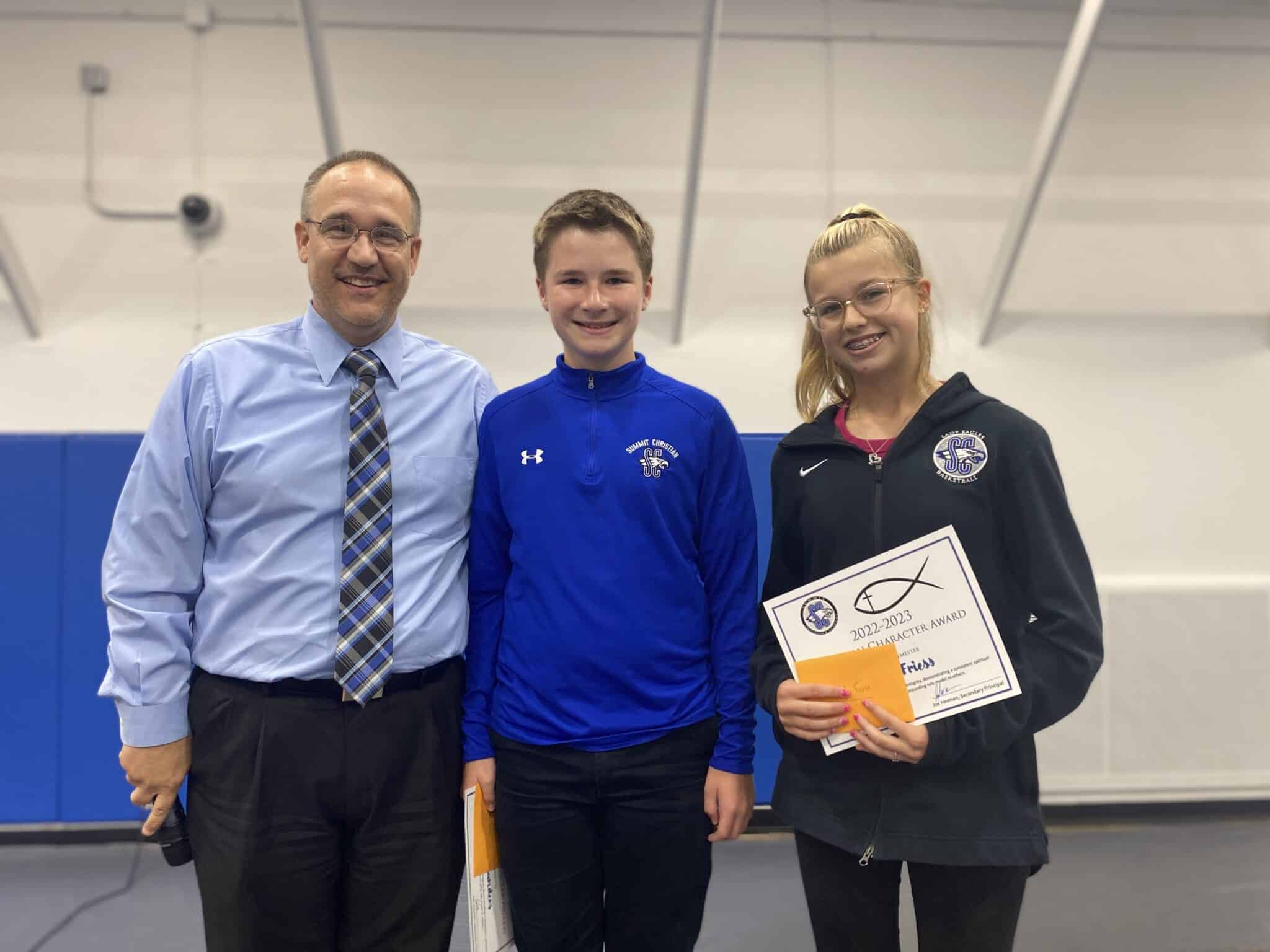 SCA presented the Junior High Christian Character award winners for second semester recently at an awards assembly. SCA Secondary Assistant Principal Joe Hesman with SCA seventh grade student Ethan Sanders and SCA eighth grade student Rylie Friess.