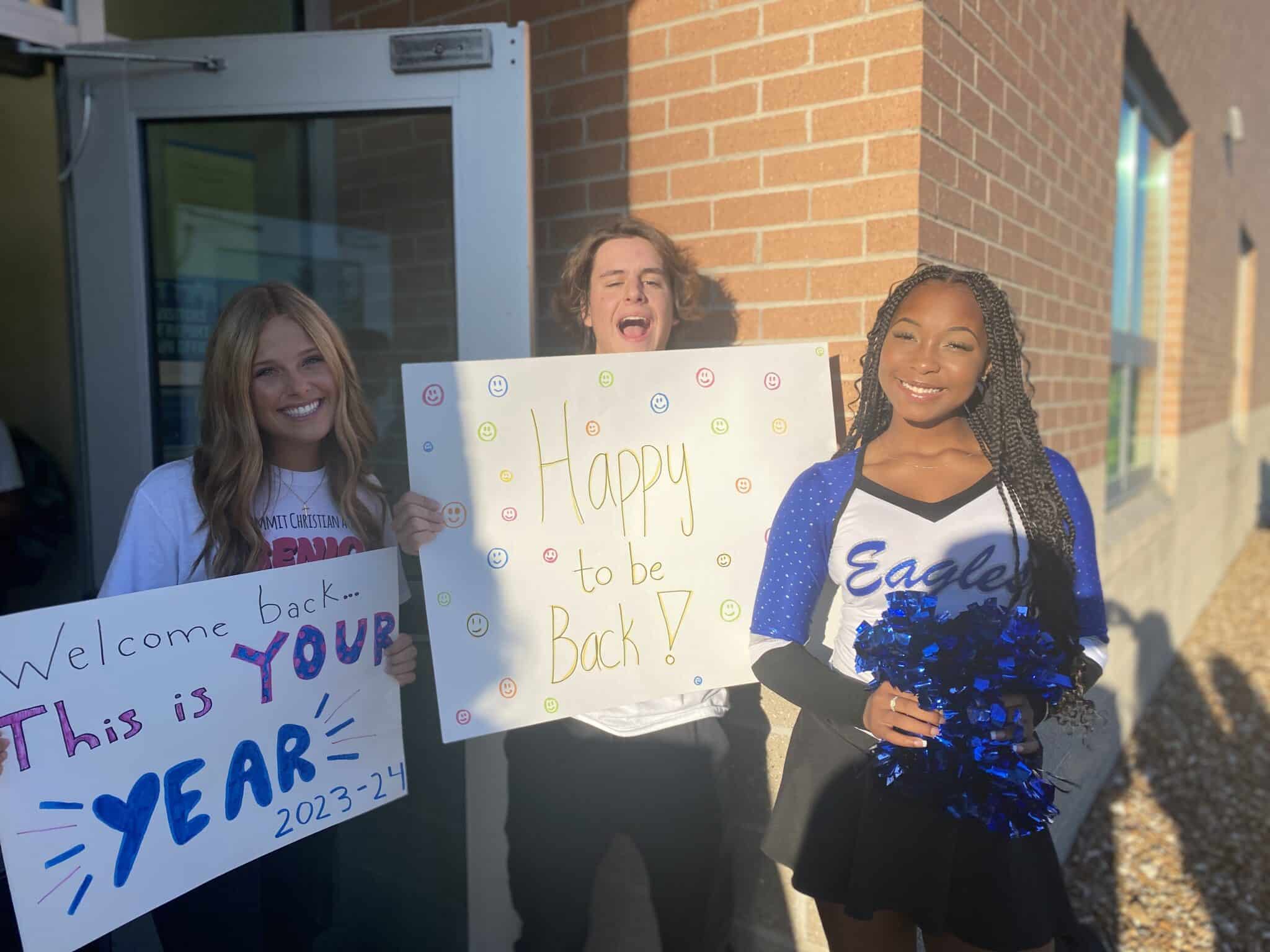 SCA Seniors Audrey Ellett and Hunter Keithley, and Junior Stevie McCanse eagerly greet students with worship music, posters, words of encouragement, and cheers as they enter their first day of school.