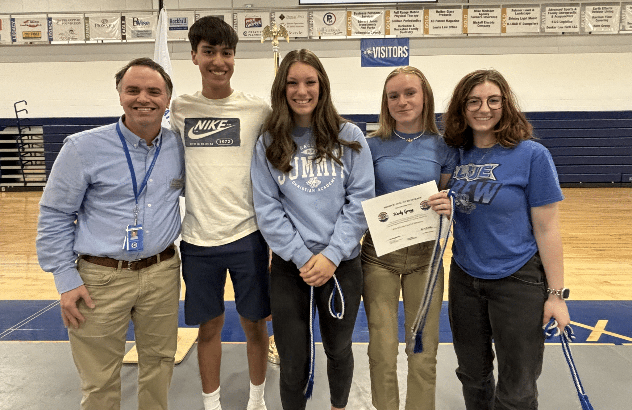 SCA International Program Director Rocco DeFelice is pictured with seniors David Beltran, Ginny Baxter, Karly Gregg, and Anna Hammond who are the recipients of the Distinguished Seal and the Seal of Biliteracy cords. SCA senior Karly Gregg (second from right) received her award for earning the award this year.