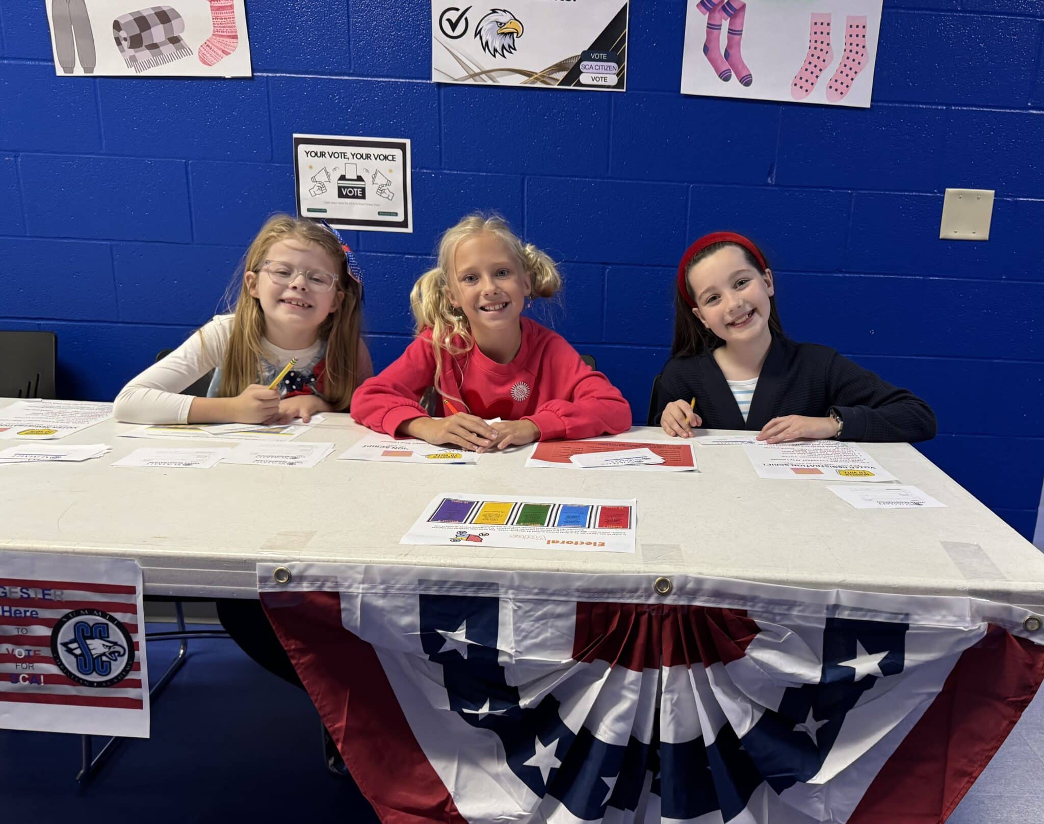 The SCA STEWARDS class recently led the elementary school in voting registration, voter identification, voting, and delivery- providing hands-on learning for their fellow elementary students. Pictured here, SCA STEWARDS class members Nora Reagan, Renley Van Maanen, and Emory Huffman assist their fellow students in the election.