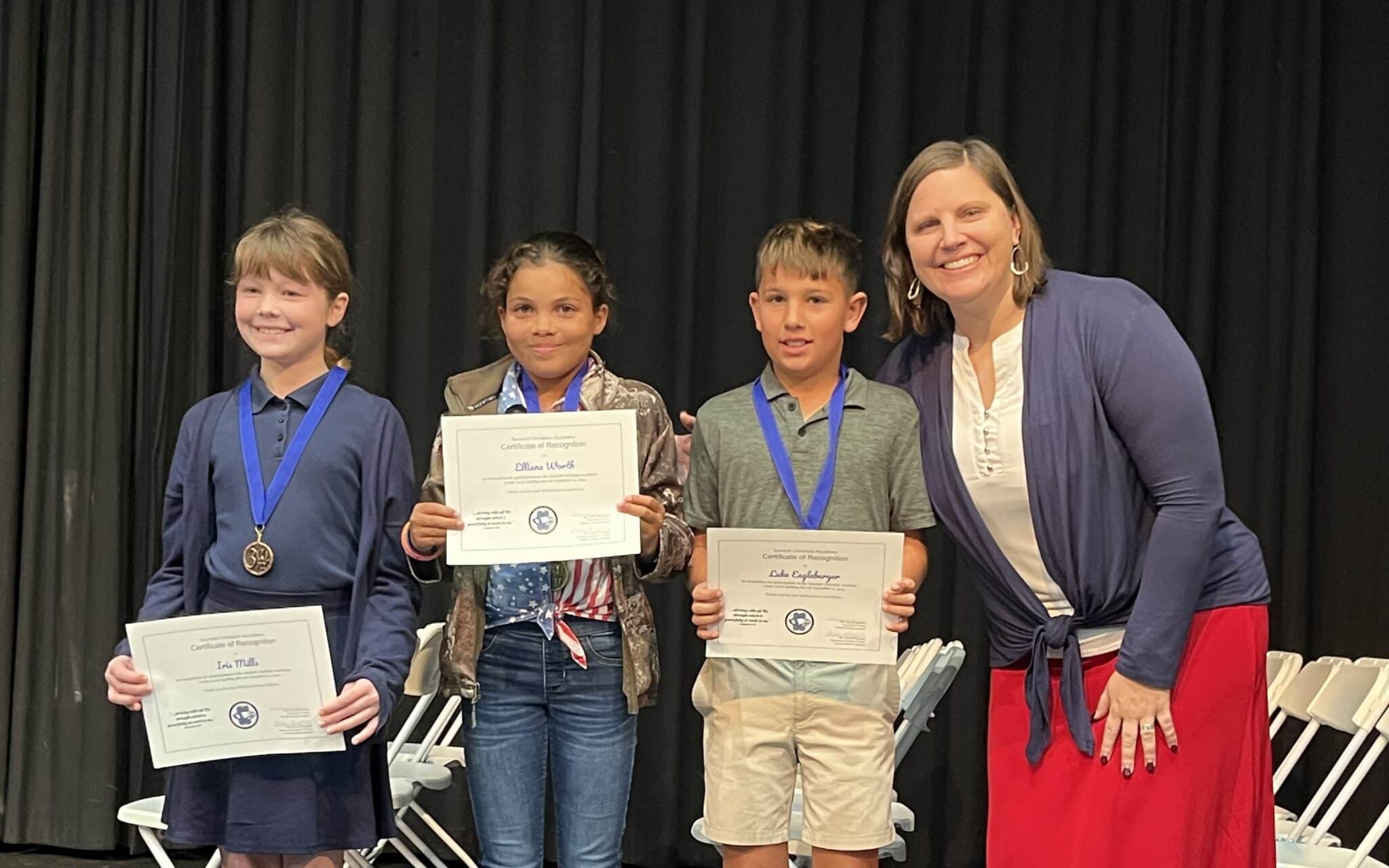 Pictured here (l-r) are SCA fourth grade spelling bee winners: third place winner Iris Mills, first place winner Elliana Worth, second place winner Luke Eagleburger, with SCA Elementary Principal Kelly Montgomery.