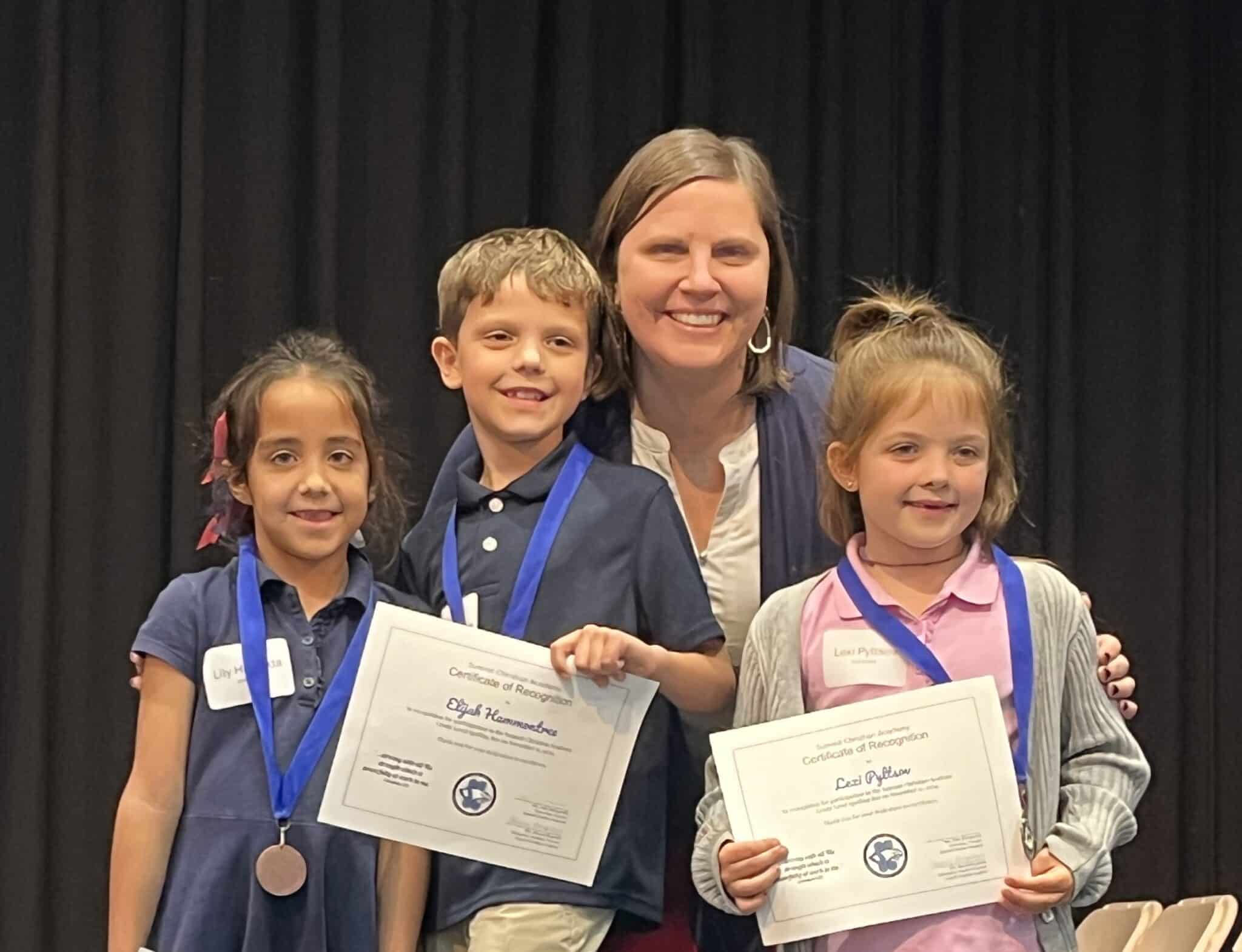 Pictured here (l-r) are SCA third grade spelling bee winners: first place winner Lexi De Jong, second place winner Juliette Hatfield, and third place winner Renley Van Maanen, with SCA Elementary Principal Kelly Montgomery.